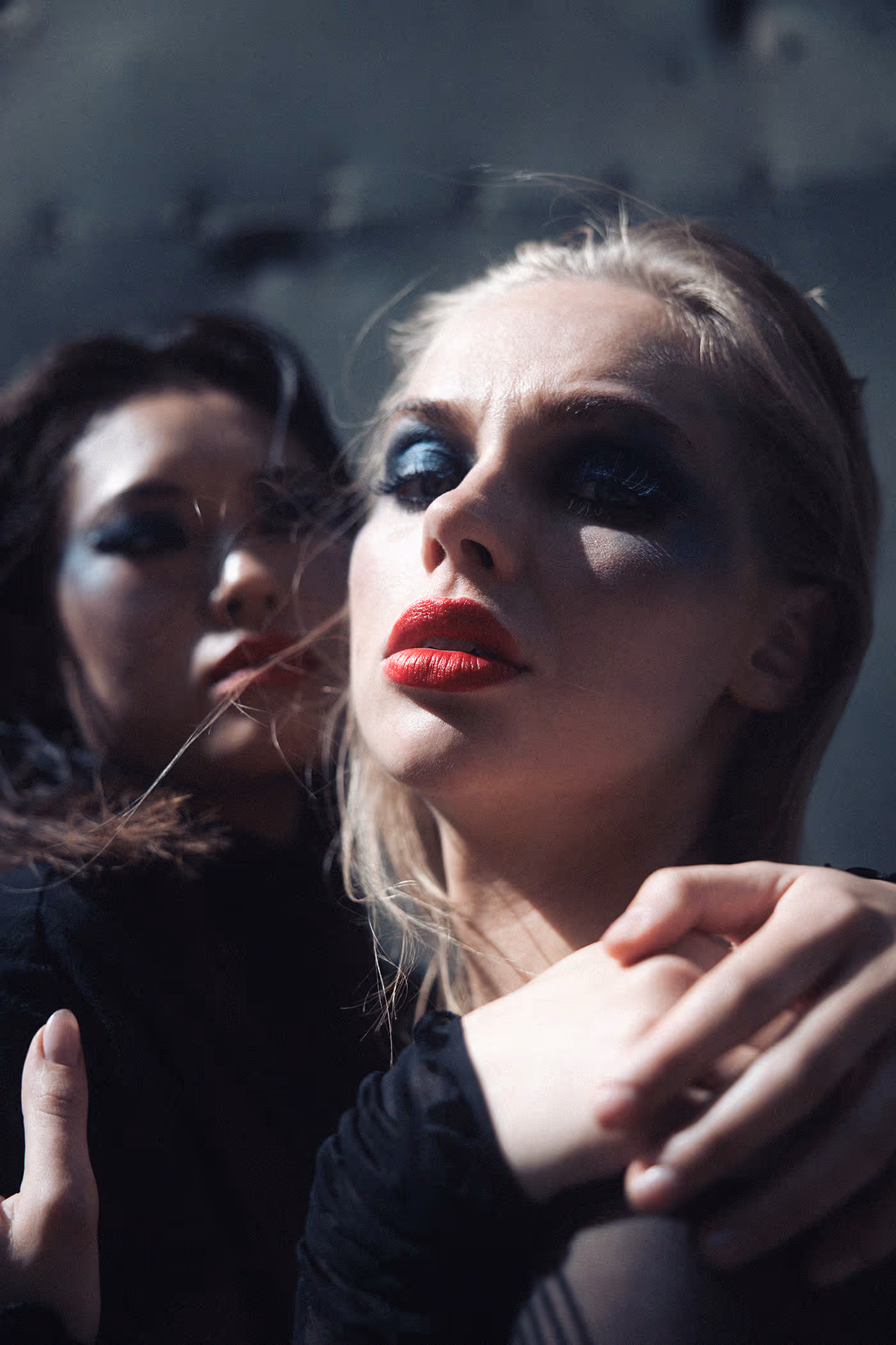 Two women embracing in a dramatic pose