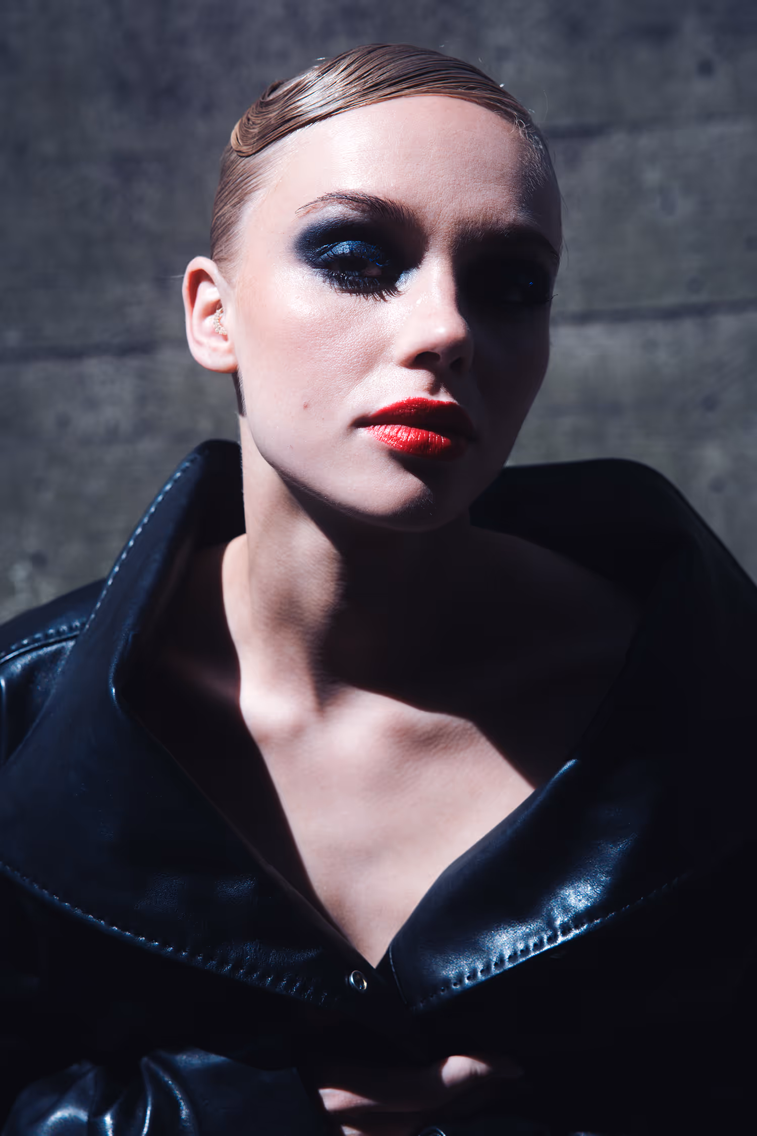 Woman in a black leather jacket in a sensual pose