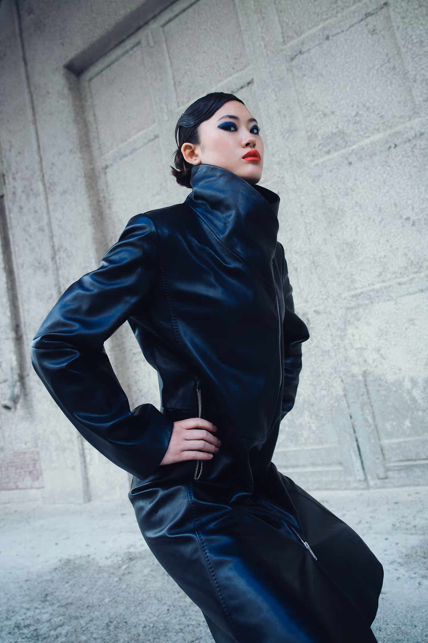Woman in a leather coat in an artistic pose